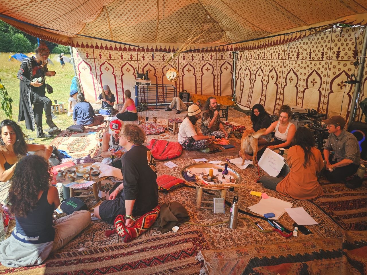 Artizens gathering and making together inside a decorated tent