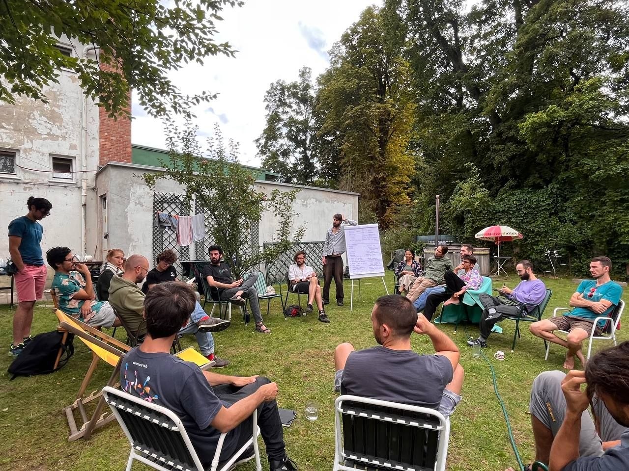 Participants in a discussion circle in the Commons Hub garden
